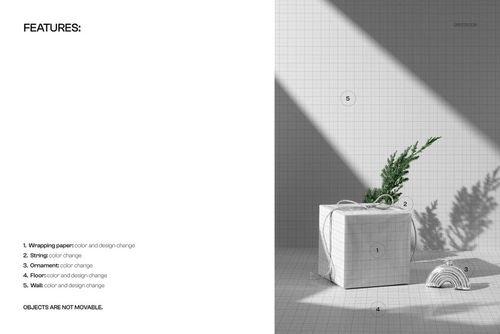 Sunlit scene featuring a mockup of a Christmas gift box with grid-patterned wrapping, string, rainbow ornament, and evergreen sprig.