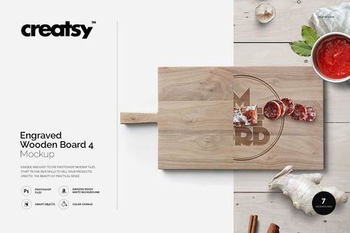 Wooden board mockup with visible engraving, displayed flat with food props including sausage slices and garlic cloves.