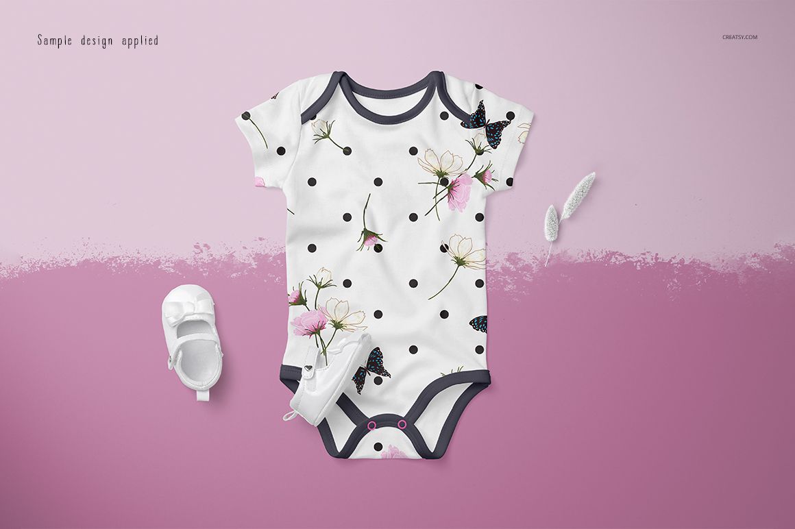 Front view of a baby onesie mockup with black trim, featuring a floral and butterfly pattern on a white background.