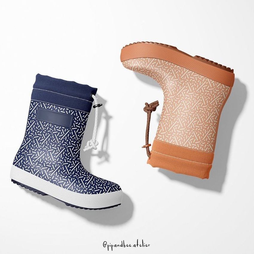 Rain boots mockup showing two boots on a white background, one navy blue and one tan, both with a white sprinkles pattern.
