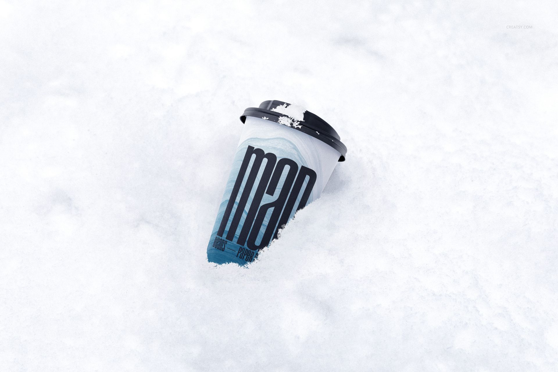 Winter-themed PSD mockup showing a drinkware paper cup with black lid and graphic print, surrounded by snow.