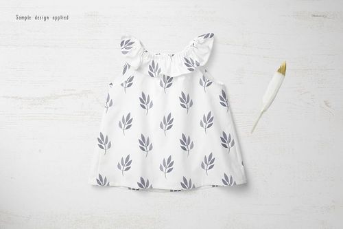 Baby summer set mockup showing a sleeveless white top with gray leaf prints, arranged on a pale wood background.
