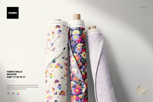 Front view of three fabric rolls featuring colorful floral designs, set against a neutral backdrop in a PSD mockup.