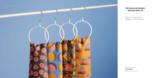 PSD mockup showing four patterned fabric scarves on white round hangers, featuring bold colors and designs.