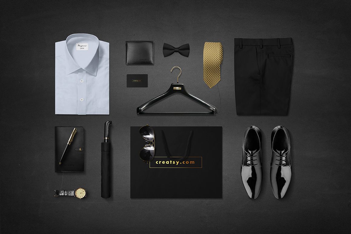 PSD mockup featuring men’s formal wear and accessories like a white shirt, gold tie, black trousers, watch, and shopping bag.