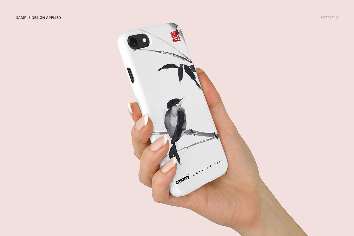iPhone 7 plastic case mockup with artistic bird and bamboo pattern, shown in a hand against a pale background.