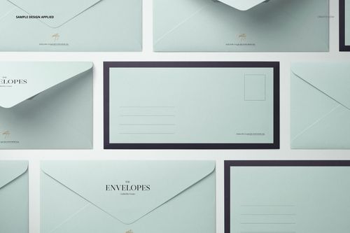 Flat lay of DL envelope mockup set in soft blue tones, featuring various envelope orientations on a neutral background.