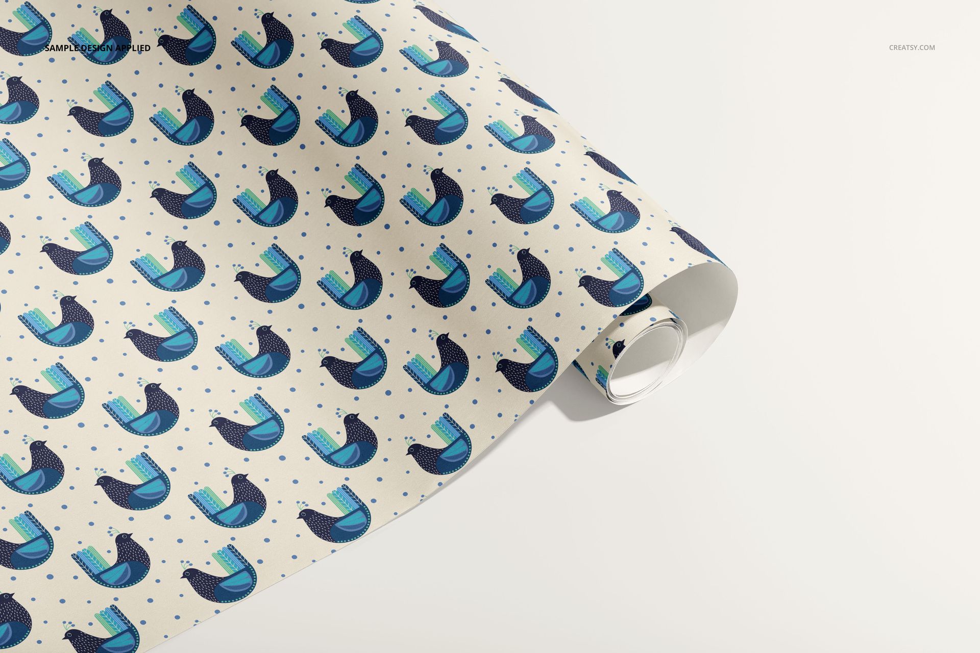 Gift wrapping paper mockup featuring a repeating blue bird design on a light background, shown partially unrolled.