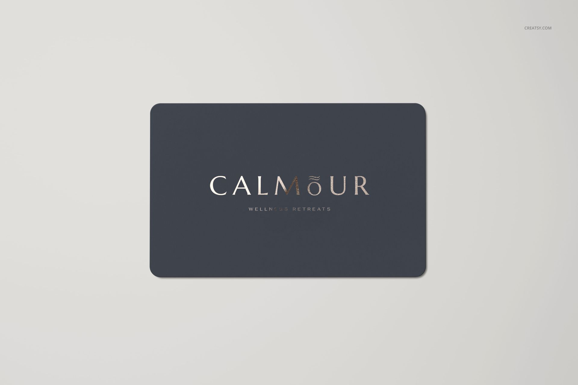 Rectangular gift card mockup with rounded corners, featuring a dark navy background and centered metallic text.