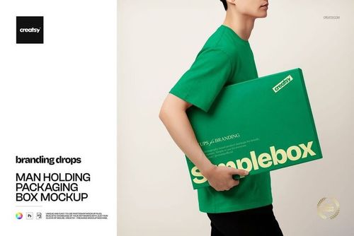 Side view of a person wearing a green t-shirt, carrying a green packaging box mockup with white text.