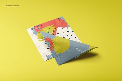 Paper napkins mockup set featuring a folded and flat napkin with bright designs, shown on a solid yellow surface.