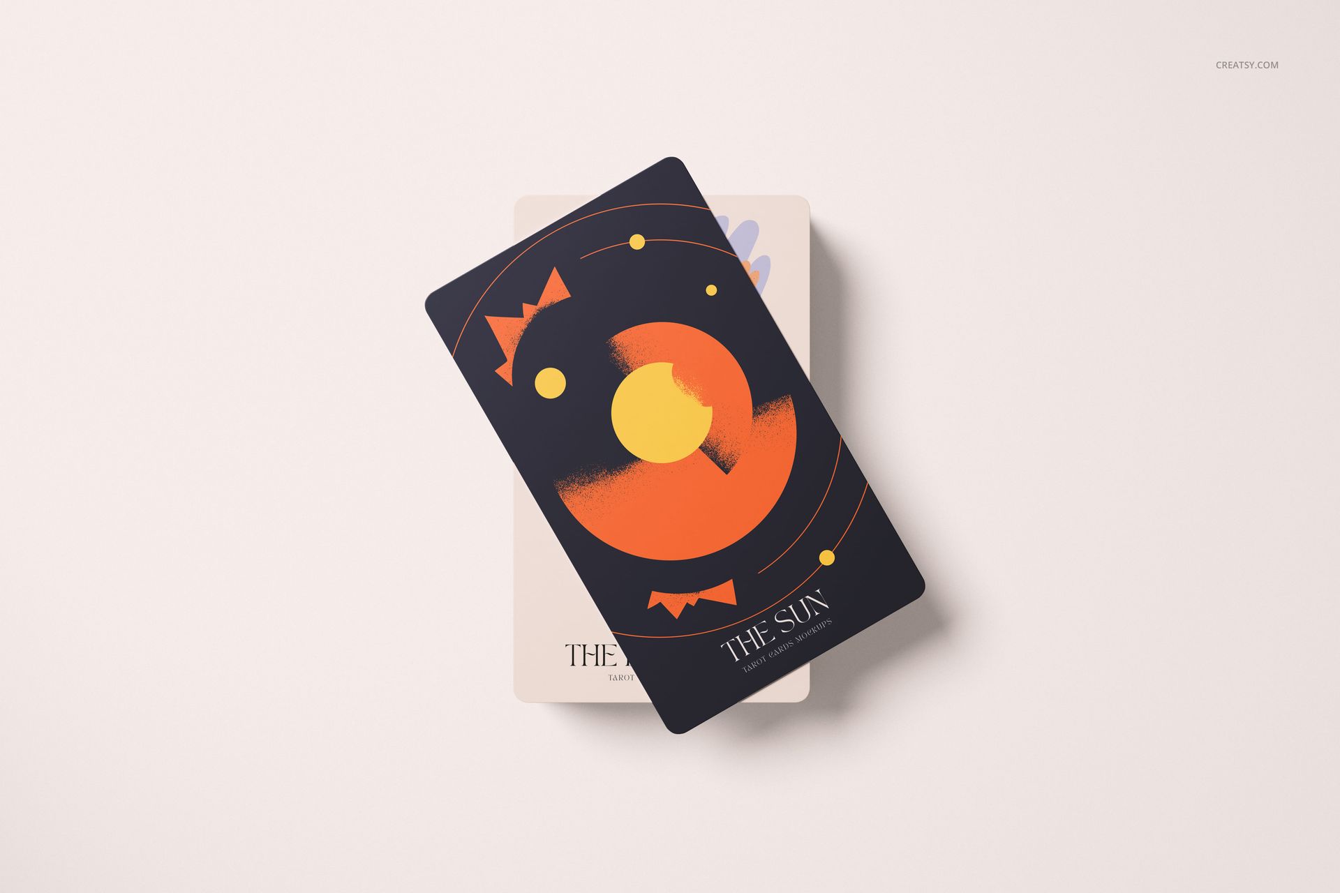 Tarot card mockup featuring a dark card with abstract orange and yellow sun design, placed over a lighter card.