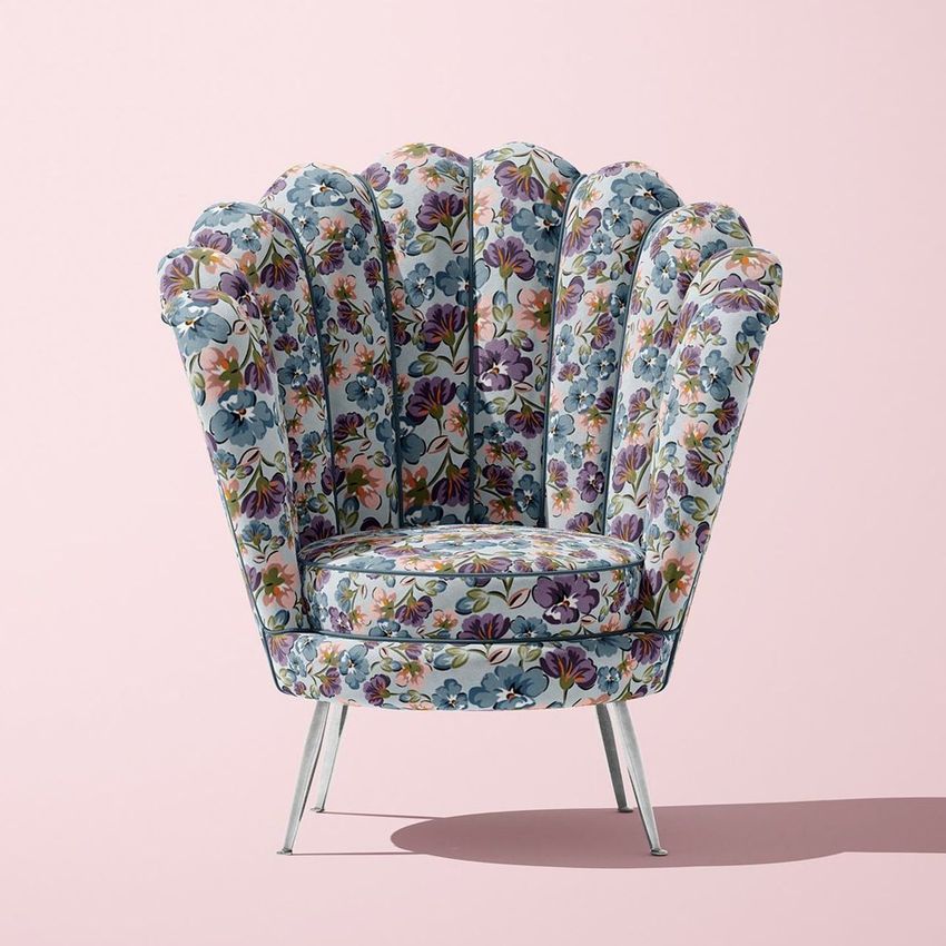 Velvet shell armchair mockup featuring a blue and purple floral pattern, set against a plain light pink background.