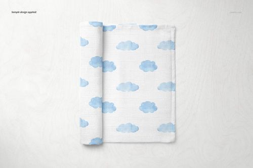 Baby muslin square nappy mockup featuring soft blue clouds printed on white fabric, displayed from above.