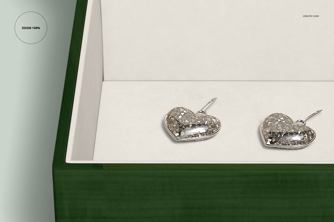 PSD mockup of a green wood jewelry box with ceramic tile detail, showing silver heart-shaped earrings inside.