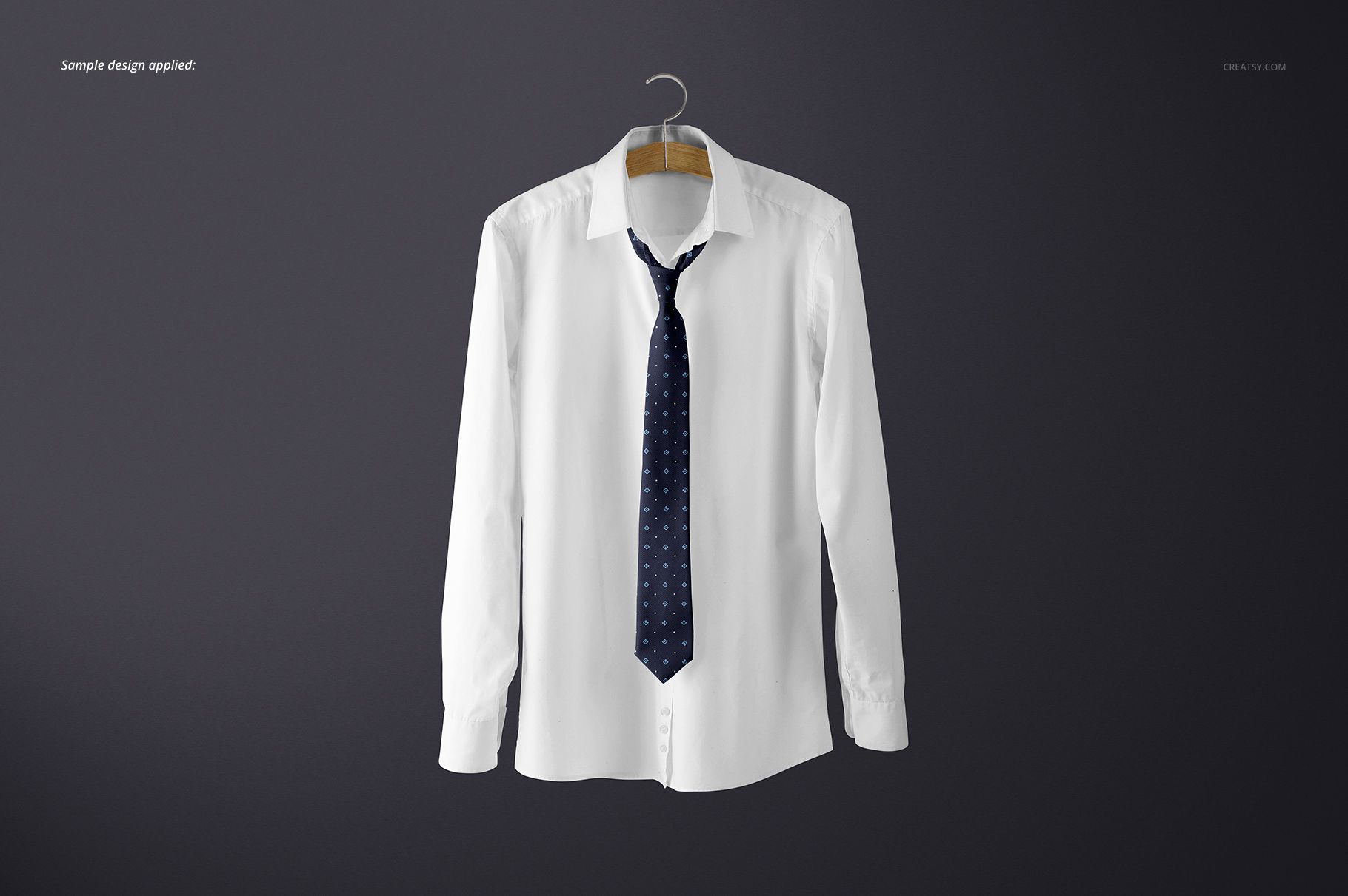 White long-sleeve shirt displayed on a hanger, featuring a navy tie with small geometric motifs, mockup scene.