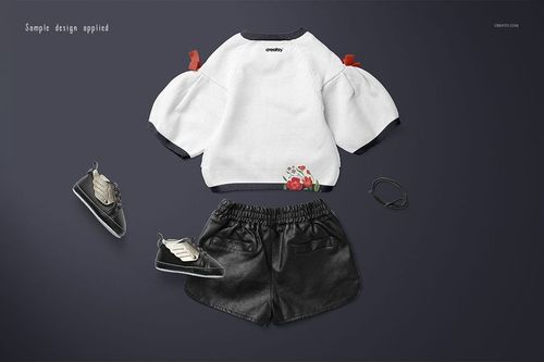 Kids sweater mockup set featuring a white long-sleeve top with floral accents, black shorts, shoes, and a bracelet on a dark background.