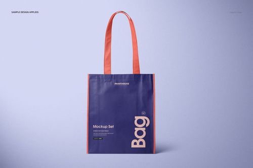 Front view of a laminated non-woven tote bag mockup with purple body, red handles, and custom text design on a light background.