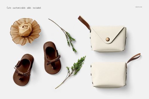 Baby summer set mockup featuring brown sandals, a beige pouch, a fabric flower, and green sprigs on a white background.