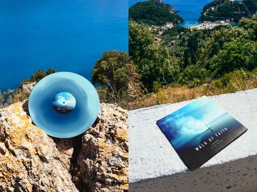 Blue colored vinyl record displayed on rocky coast with scenic ocean view, shown in a music PSD mockup set.