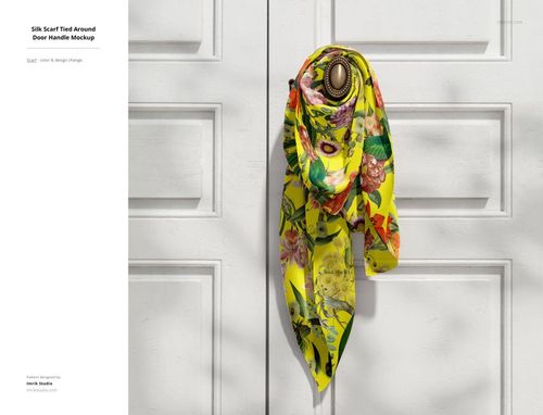 PSD mockup of a bright floral silk scarf wrapped around a classic door handle on white double doors, direct perspective.