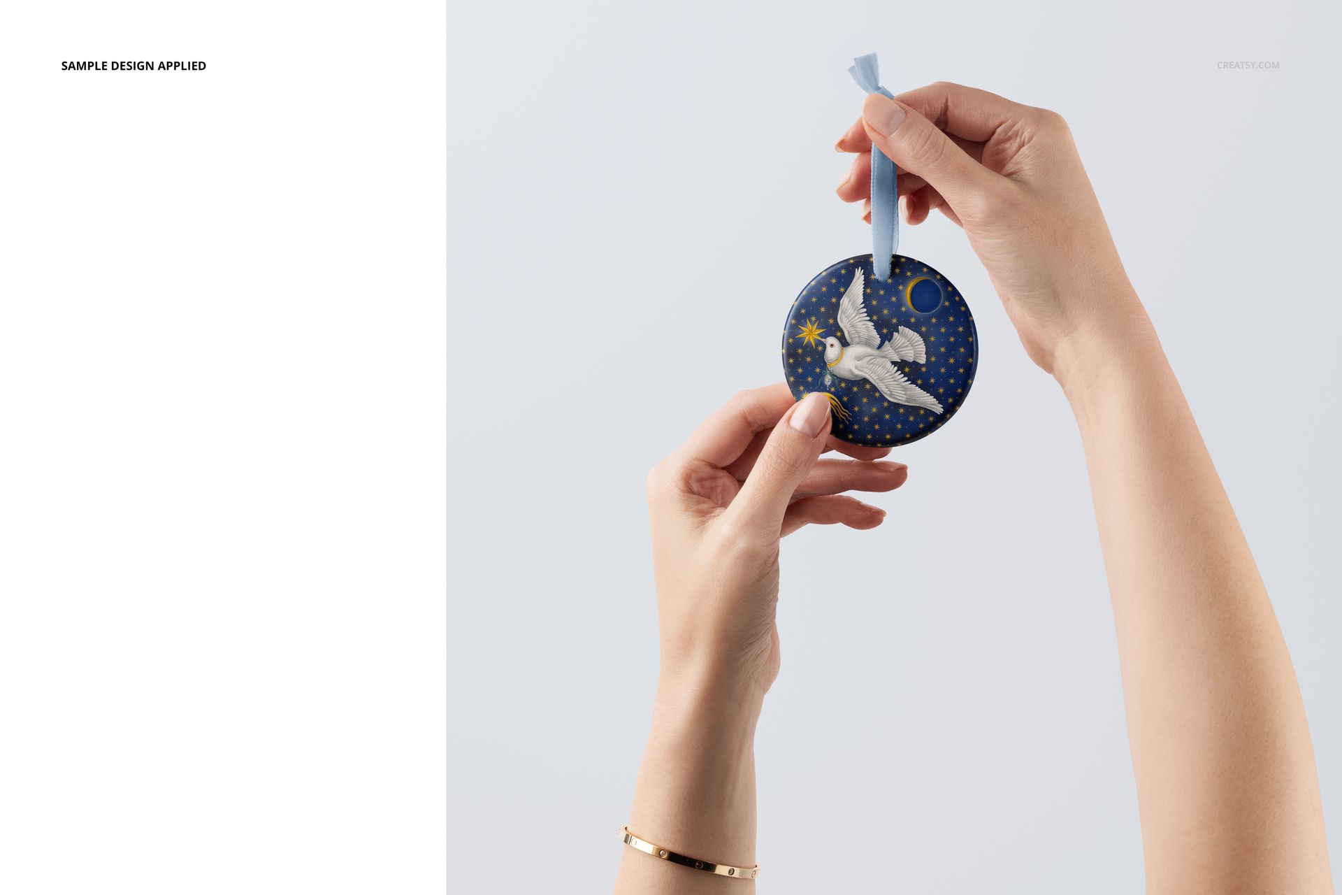 Handmade round ornament mockup featuring a blue and yellow pattern, suspended by a light blue velvet ribbon.