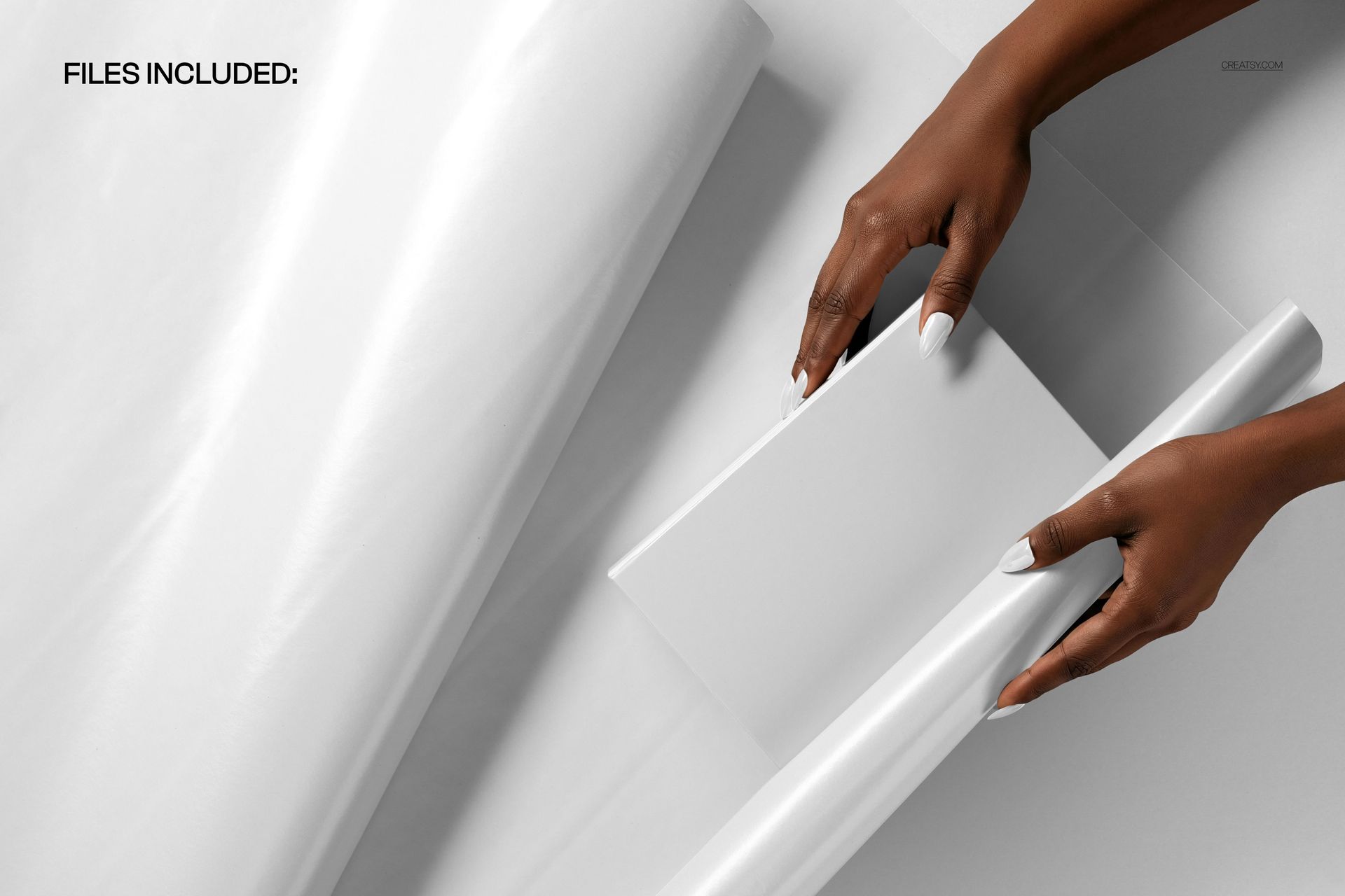 PSD mockup featuring hands preparing to wrap a simple white gift box with shiny white wrapping paper.