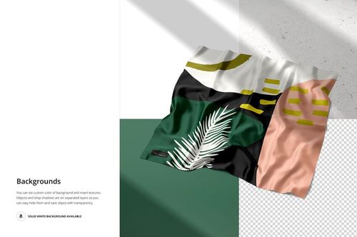 Silk fabric mockup with abstract green, black, pink, and white sections, shown from an angled top view on a white surface.