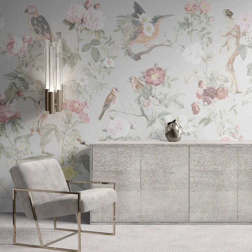 Armchair and sideboard mockup in a room with a floral and bird patterned wallpaper, soft gray tones, and a modern wall sconce.
