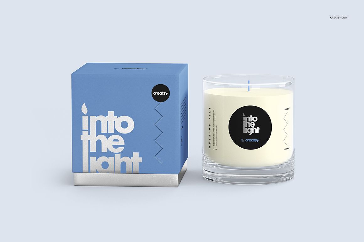 Scented candle mockup set featuring a transparent glass candle with white wax and a matching blue packaging box.