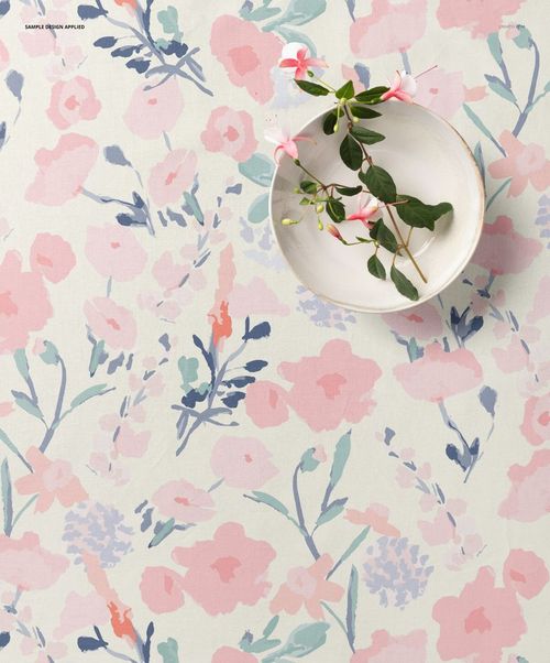 Cotton fabric mockup shown from above, decorated with soft pink and blue floral designs and a bowl with flowers.