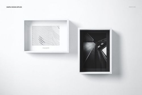 Two wooden picture frames in white finish, one horizontal and one vertical, displayed on a plain white wall.
