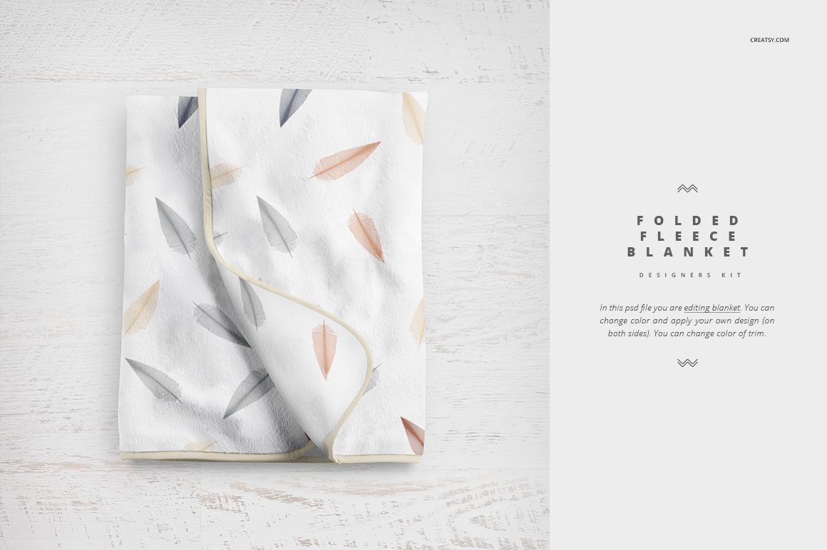 PSD mockup of a folded baby blanket featuring soft colored feathers, shown from above on a pale background.