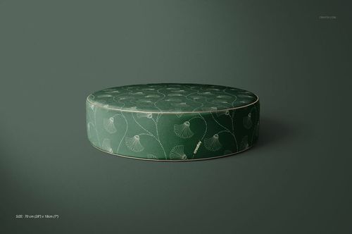Green velvet pouf mockup featuring a circular shape and delicate botanical design, displayed on a solid background.