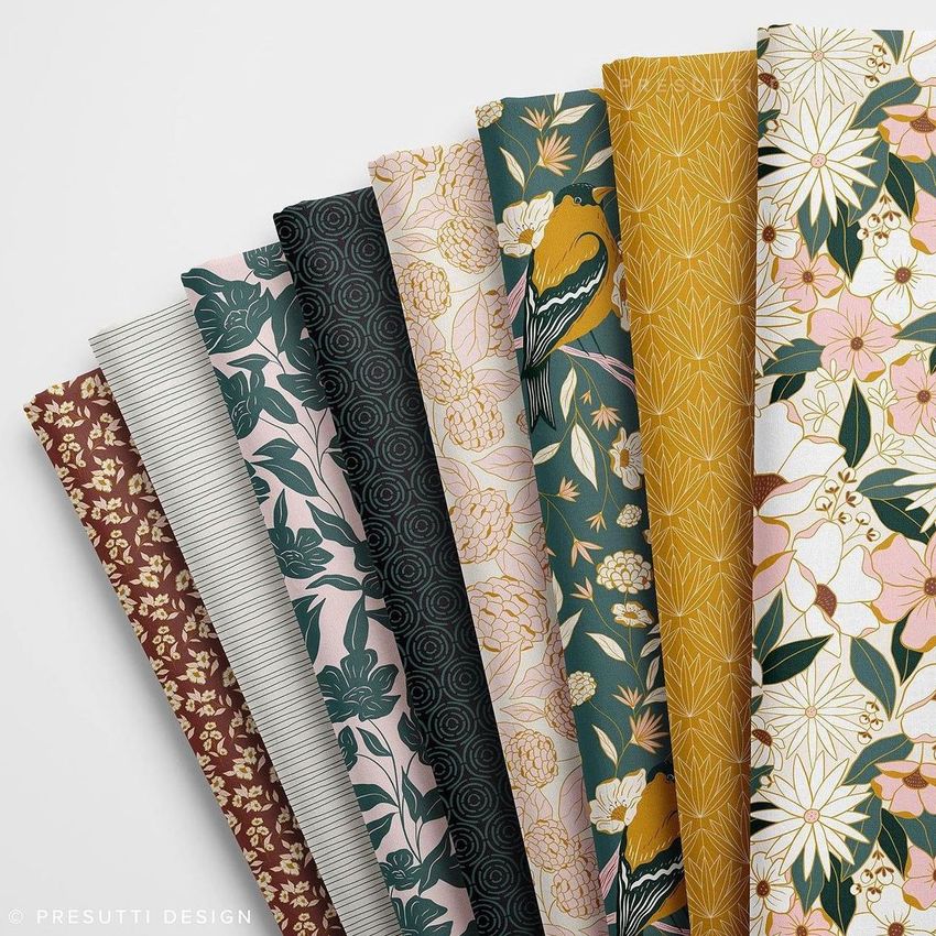 Folded fabrics mockup featuring eight fabric pieces arranged side by side, each with distinct floral and geometric patterns.