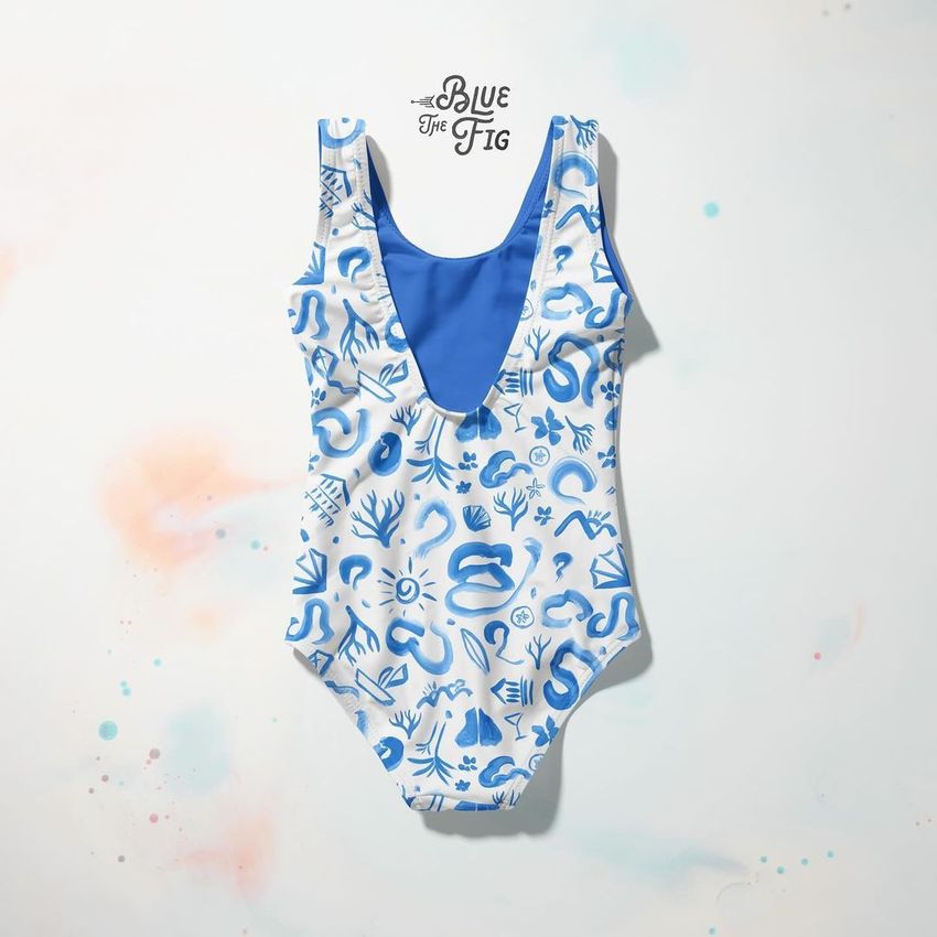 Baby swimsuit mockup featuring a one-piece suit with blue and white abstract patterns, displayed on a light background.
