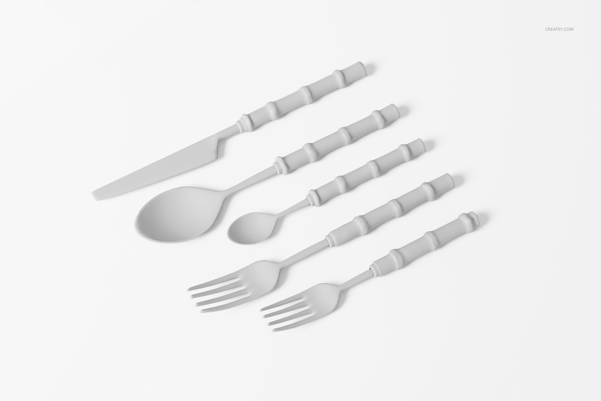 Five-piece bamboo cutlery set including knife, spoon, teaspoon, and two forks arranged on a white surface.