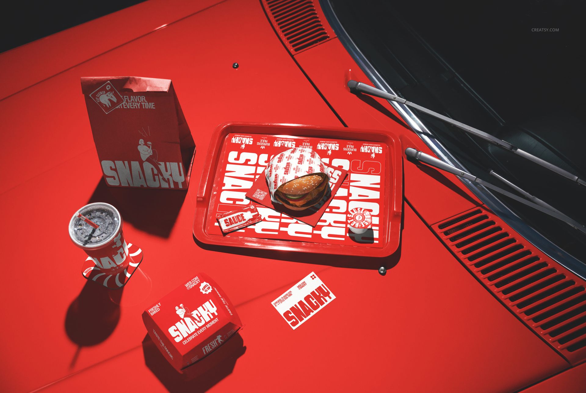 Fast food restaurant branding mockup featuring a burger tray, drink cup, burger box, and paper bag on a red car hood.
