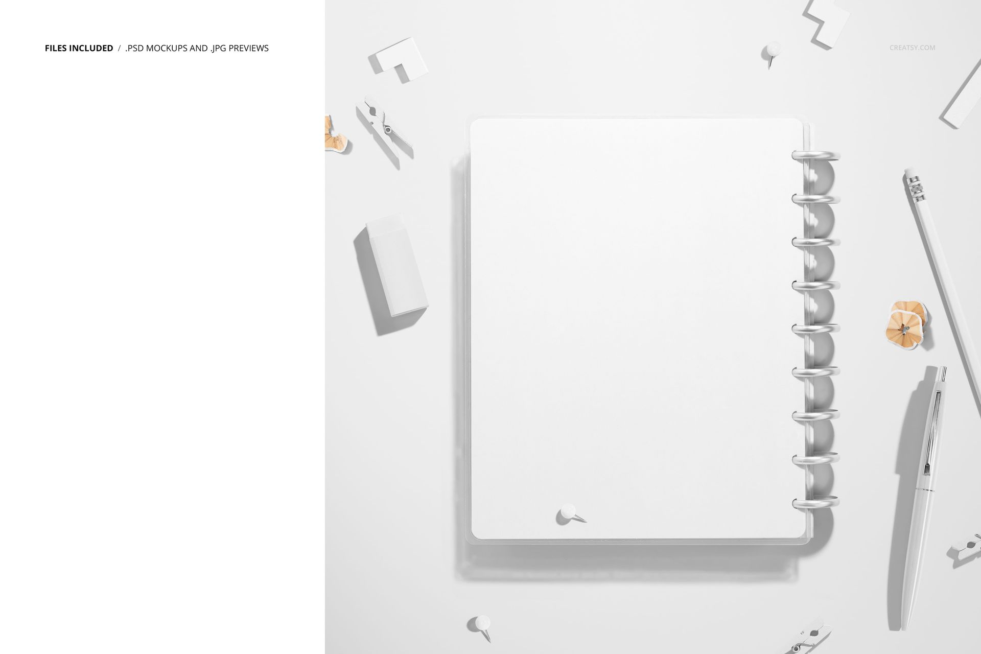 Top-down perspective of a spiral planner mockup, featuring a blank white cover and surrounded by small office supplies.