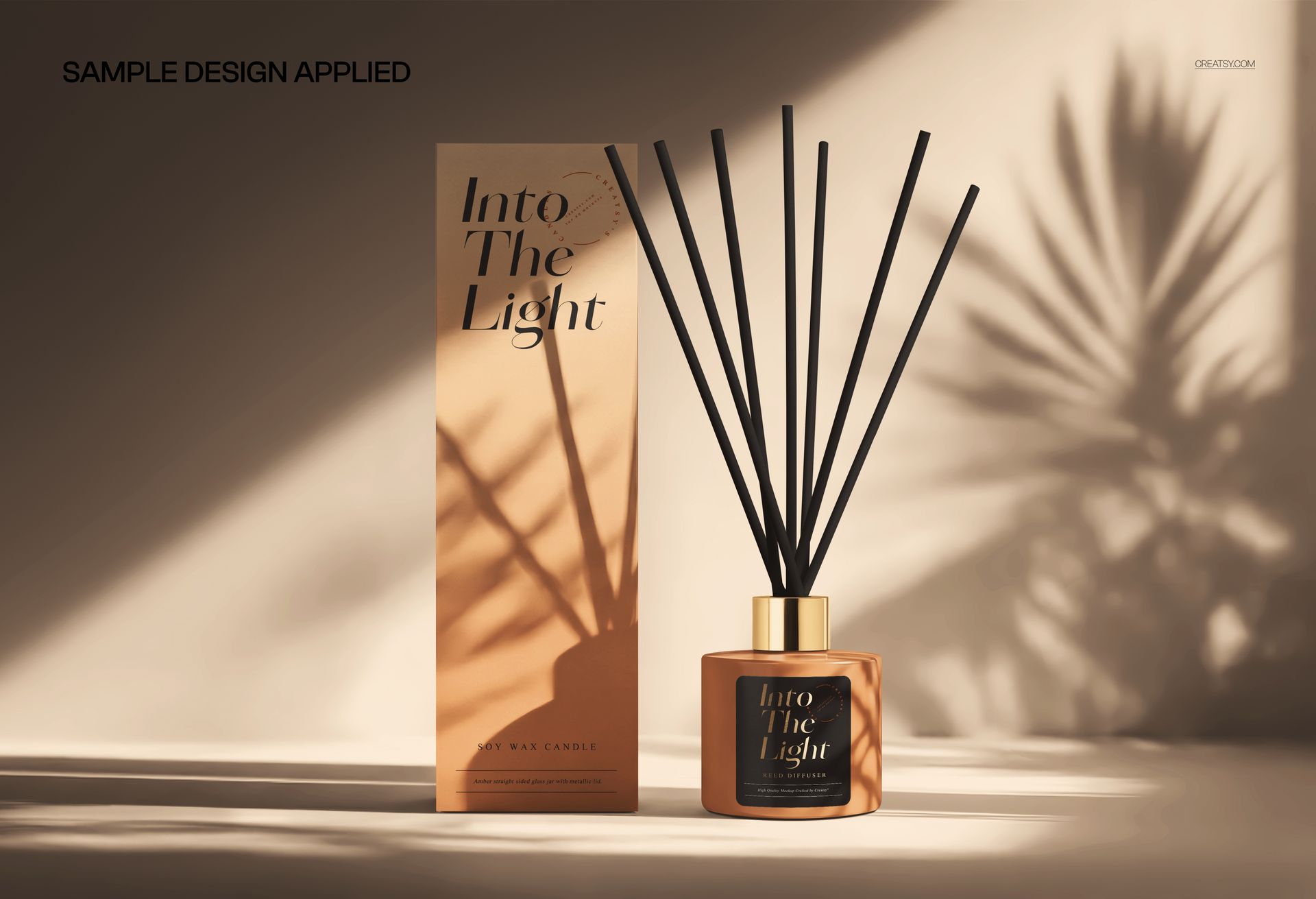 PSD mockup showing reed diffuser jar and packaging box, illuminated by sunlight with decorative leaf shadows.