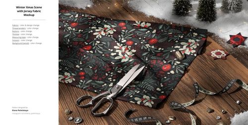 Top view of patterned jersey fabric mockup with scissors, pine trees, and Christmas decorations on a wooden table.