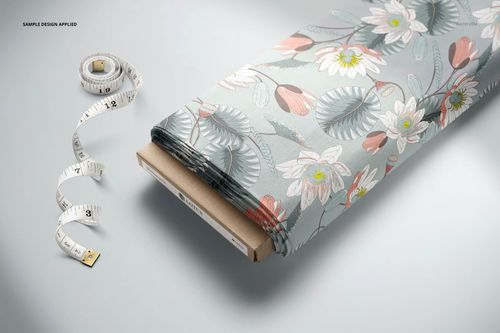 PSD mockup of a fabric bolt featuring a botanical design in muted tones, displayed beside a measuring tape.