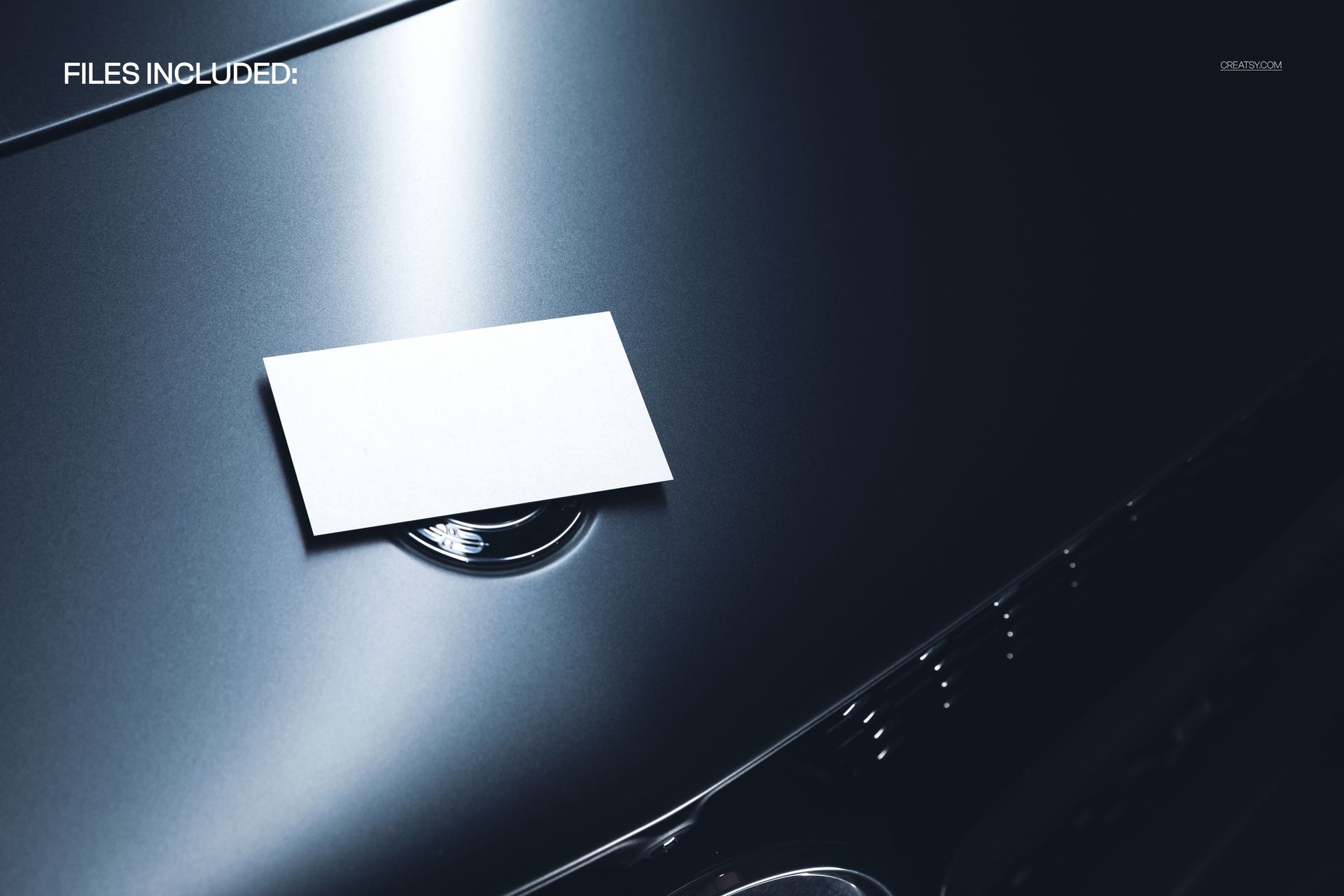 PSD mockup showing a blank business card on a shiny luxury car hood with subtle chrome accents and soft lighting.