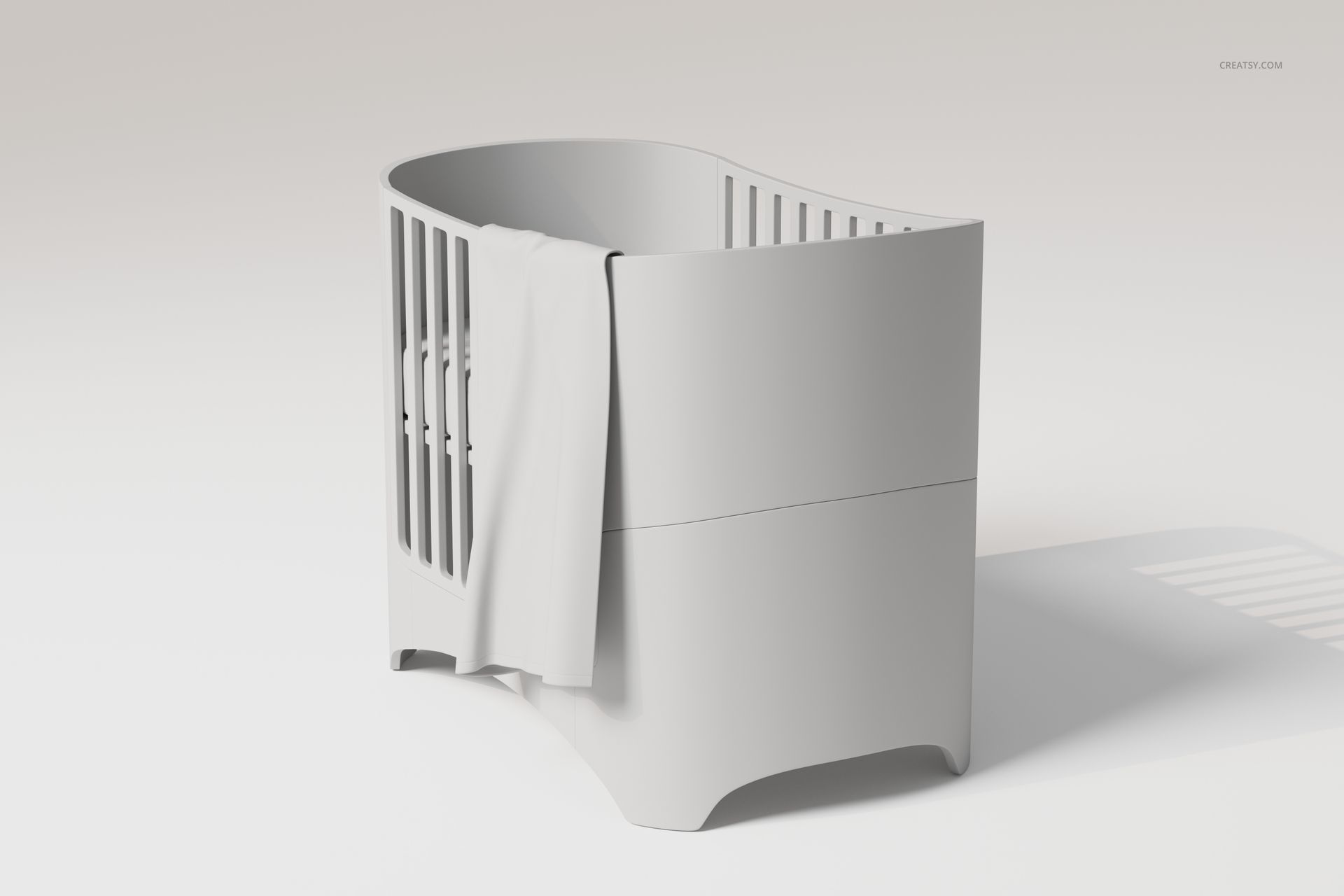 Modern crib with rounded edges in light gray, featuring a large baby blanket draped over one side, front angle view.