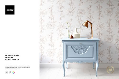 Home interior mockup featuring a pastel blue ornate dresser, floral patterned wallpaper, gold desk lamp, and white vase.