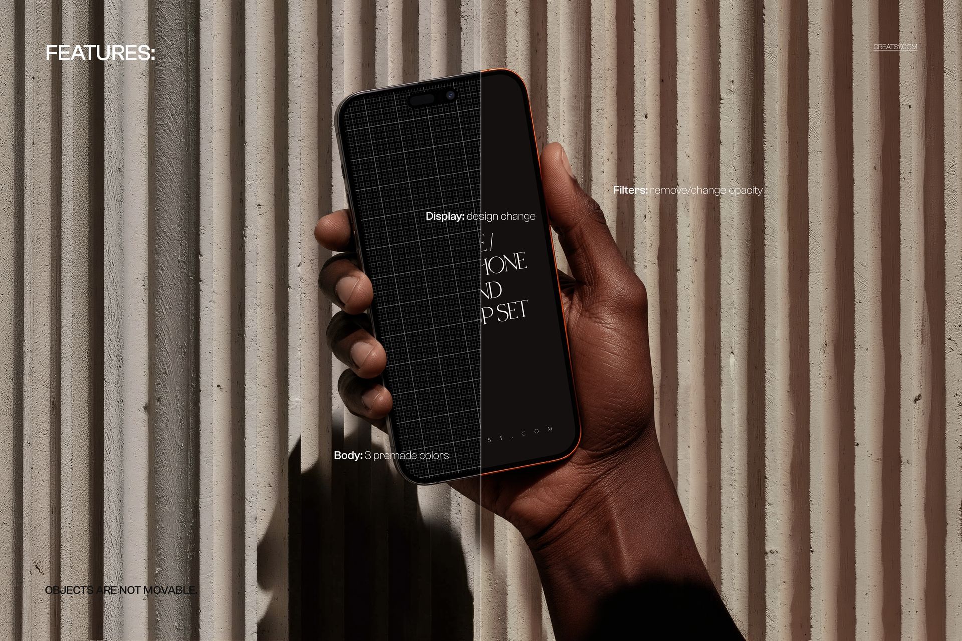 Hand holding a black iPhone with a dark screen, positioned against a ribbed concrete wall, front view mockup.