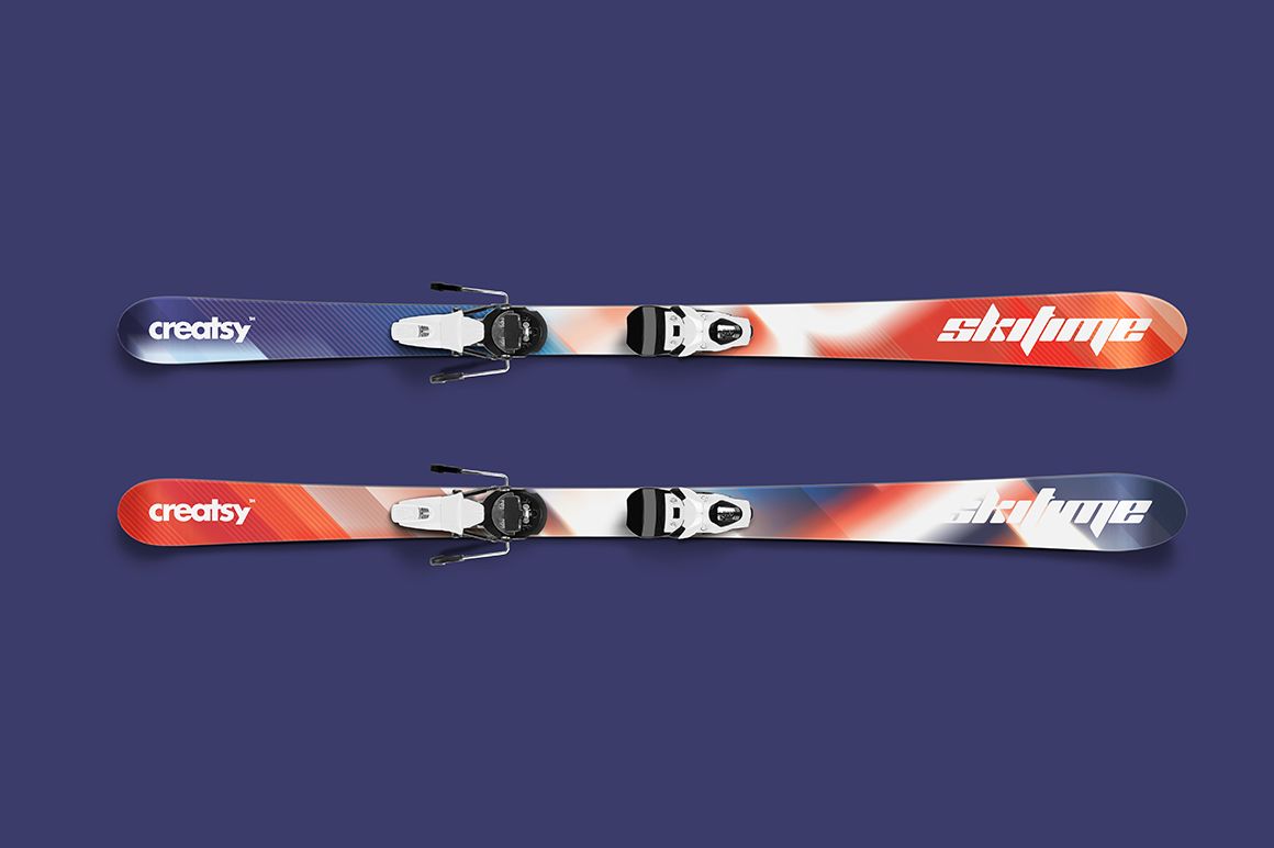 Ski mockup showing two skis with bold red and blue color gradients, viewed from above against a plain blue backdrop.