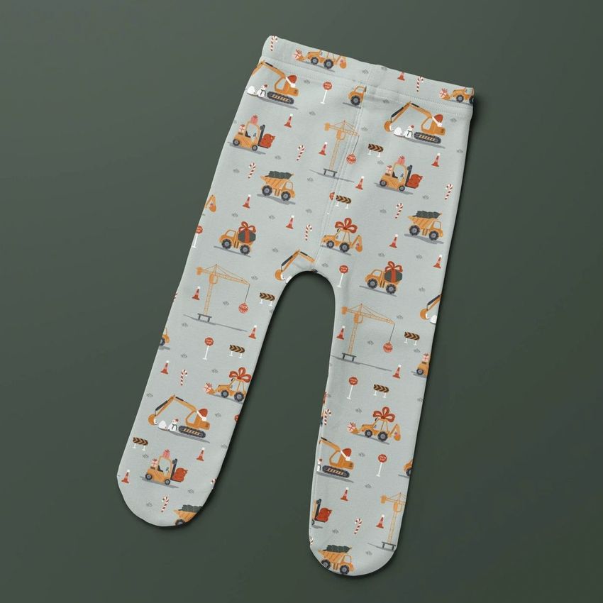 Footed baby leggings mockup displayed flat on a dark green background, featuring a playful construction vehicle pattern.