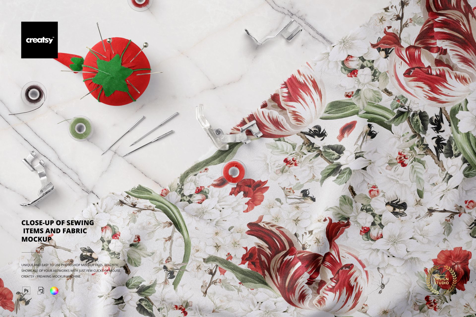 PSD mockup showing sewing accessories, needles, and spools next to a piece of patterned fabric on a white background.