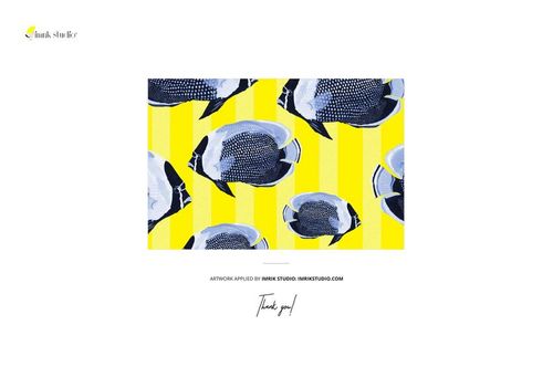 Folded jersey fabric mockup with blue and black fish design over yellow stripes, tailoring tools not visible, front perspective.